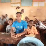 Charles with school children