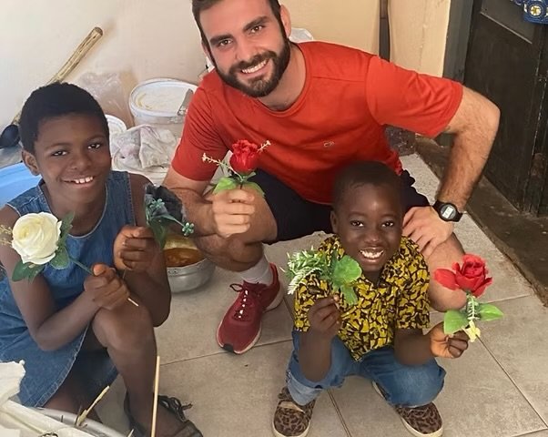 Foster Care & Reintegration 2 Children and a volunteer in a supportive community setting